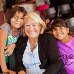 Two young kids pictured with community leader